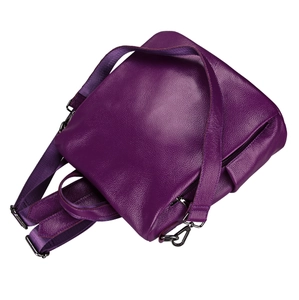 Detail view of purple pebbled leather backpack with silver hardware and woven straps