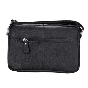 Detail view of the black pebble leather crossbody bag showing back zipper pocket and strap