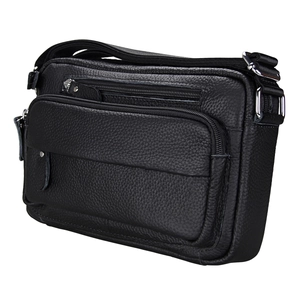 Detail view of black pebble leather crossbody bag with multiple silver zipper pockets