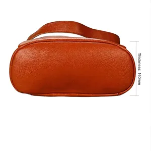 Genuine leather backpack in brown-orange pebble grain, showing 160mm bottom thickness
