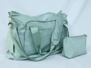 Detail of mint green waterproof travel bag set with matching small zipper pouch