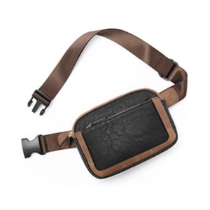Detail view of black PU leather waist bag with brown trim and adjustable wide nylon strap