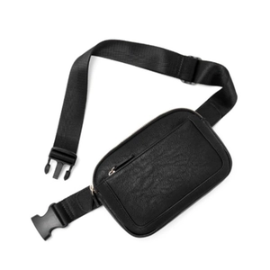 Detail of black faux leather waist bag with lychee texture and adjustable strap