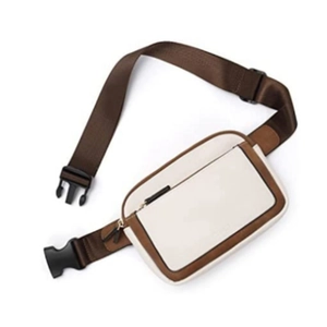 Detail of two-tone crossbody waist bag in beige and brown with adjustable strap