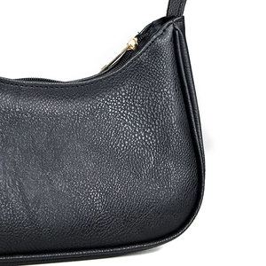 Black pebbled leather hobo shoulder bag with gold zipper and minimalist design
