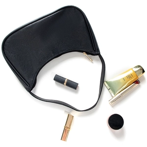 Top view of black crescent bag showing internal capacity with lipstick and sunscreen