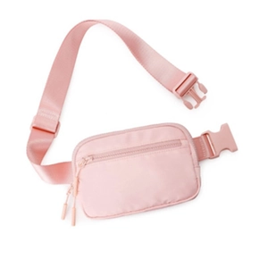 Close-up of pink nylon waist bag with durable zippers and adjustable plastic buckle