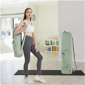 Detail of sage green yoga mat bag with adjustable strap and side zipper pocket
