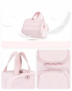 Detail view of pink quilted travel toiletry bag with lightweight handles and dual zippers