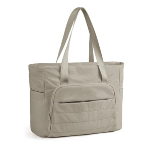 Detailed view of the functional front zipper pocket and quilted khaki nylon tote bag