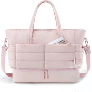 Detail view of pink quilted travel bag with bottom shoe compartment and double front pockets