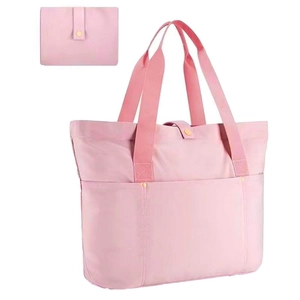 Detail of light pink nylon tote bag with matching foldable pouch and snap button