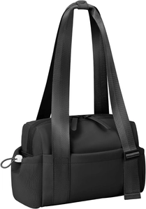 Detail of black waterproof sports bag featuring multi-pocket layout and sturdy nylon straps