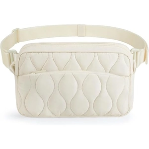 Detail view of cream-colored quilted fanny pack featuring wave stitching and adjustable strap