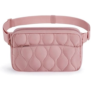 Detailed view of pink quilted fanny pack with adjustable strap and wave stitching