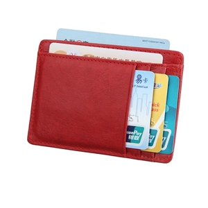 Slim red genuine leather card holder with multiple vertical slots and pebble texture