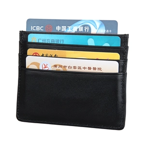 Detail of slim black leather card holder showing four slots and reinforced stitching