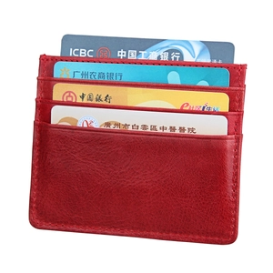 Detail showing red leather card holder with multiple vertical slots and stitched edges
