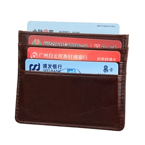 Detail of dark brown leather card holder featuring 4 slots and premium stitched edges