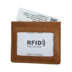 Detail of brown RFID genuine leather card holder with lychee texture and transparent slot