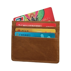 Detail of premium brown genuine leather card holder with four card slots and visible grain