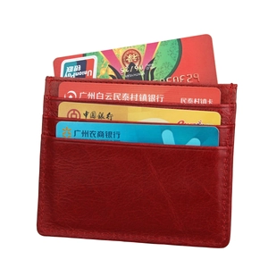 Close-up of red RFID leather card holder with multiple slots and lychee texture