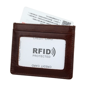 Macro detail of dark brown leather card holder with RFID protection and clear ID window