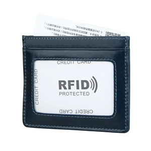 Detail view of deep blue RFID leather card holder with clear ID window and card slots