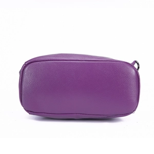 Detailed bottom view of purple pebbled leather backpack showing stitch quality and D-ring