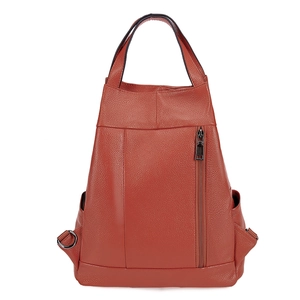 Detail view of burnt orange leather backpack with top handle and side pockets