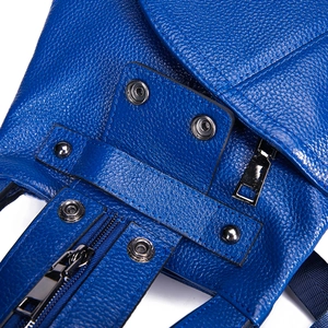 Macro shot of royal blue lychee grain leather texture with silver metal snaps and zipper