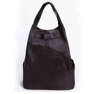 Detail of dark brown leather backpack with lychee grain texture and zipper pocket