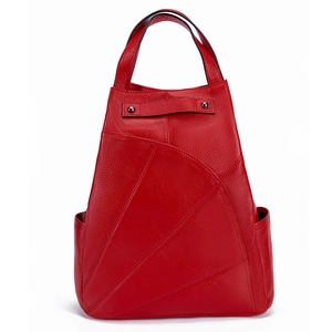 Detailed view of red lychee grain leather backpack with unique triangular patchwork design