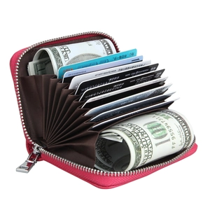 Macro view of rose red leather accordion card holder with multiple slots and RFID lining