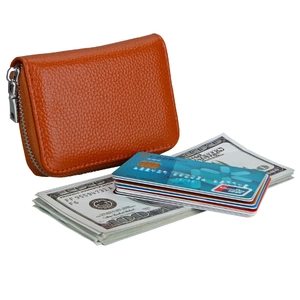Macro detail of orange leather accordion card holder showing internal RFID slots and cash