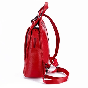 Detail view of red lychee grain leather backpack with metal zipper and adjustable straps