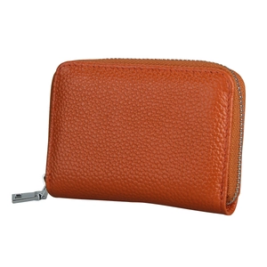 Macro shot of orange pebble leather accordion card holder with silver metal zipper