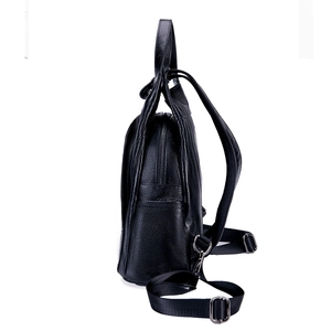 Side view of black lychee grain leather backpack with silver hardware and adjustable strap