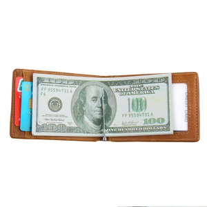 Detail view of brown leather wallet with silver metal money clip and multiple card slots