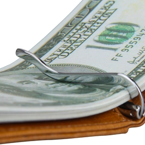 Detail of a shiny metal money clip holding dollar bills inside a brown leather wallet
