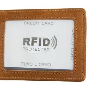 Macro detail of brown leather wallet featuring RFID protected card slot with precise stitching