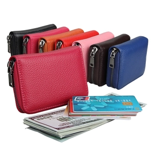 Macro view of multi-color leather card holders with litchi texture and metal zipper