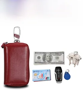 Macro view of red genuine leather car key pouch with zipper and inner storage detail