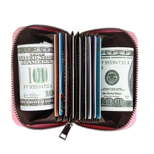 Internal view of pink leather card holder with accordion slots and silver zipper detail