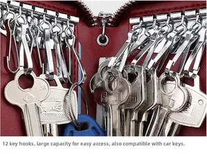 Detail showing red leather key case with twelve polished silver metal rotating hooks inside