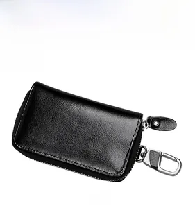 Detail view of black lychee leather car key pouch with U-shaped zipper and metal clip hook