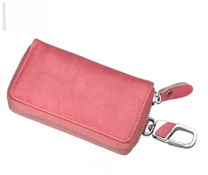 Side view of blush pink pebbled leather car key case with silver zipper and carabiner