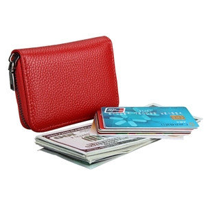 Detailed view of red leather card holder with zip closure and large storage capacity