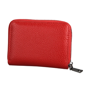 Detail of red genuine leather card holder featuring pebble grain texture and metal zipper