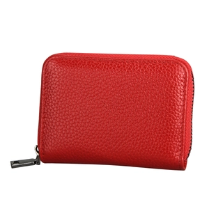 Close-up of red pebbled leather card holder with premium metallic zipper detail